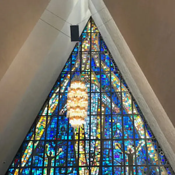 Large triangular stained glass window in blue and gold