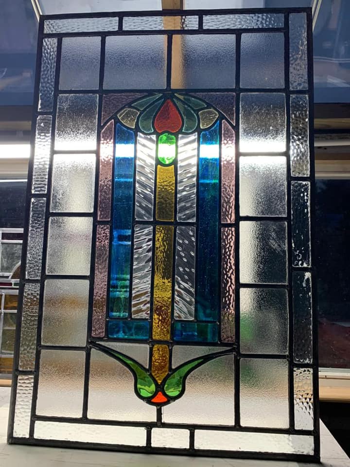 An original window that was bowed and broken. Repaired and refitted.
